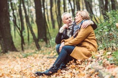 Beautiful mature couple in autumn park Stock Images Beautiful mature couple in autumn park Stock Images