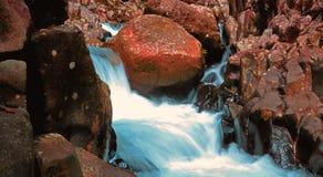 Beautiful mini waterfall landscape surround by orange rock in slow motion photography royalty free stock image Beautiful mini waterfall landscape surround by orange rock in slow motion photography royalty free stock image