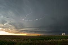 Supercell rotating thunderstorm at sunset with lightning bolt over Colorado stock photo Supercell rotating thunderstorm at sunset with lightning bolt over Colorado stock photo