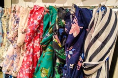 Beautiful multi-colored scarves on a hanger, background stock photos Beautiful multi-colored scarves on a hanger, background stock photos
