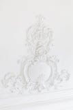 Beautiful ornate white decorative plaster mouldings in studio. The white wall is decorated with exquisite elements of royalty free stock images Beautiful ornate white decorative plaster mouldings in studio. The white wall is decorated with exquisite elements of royalty free stock images