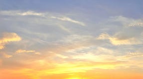 Beautiful panorama of orange and yellow cloudscapes at sunrise/sunset  on a blue sky in high resolution
