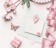 Beautiful Pastel Pink Layout With Flowers Decoration,ribbon, Hearts And Card Mock Up On White Desk Background, Top View, Flat Lay. Royalty Free Stock Image Beautiful Pastel Pink Layout With Flowers Decoration,ribbon, Hearts And Card Mock Up On White Desk Background, Top View, Flat Lay. Royalty Free Stock Image