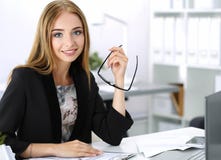 Beautiful pensive businesswoman sitting at her working place royalty free stock photography Beautiful pensive businesswoman sitting at her working place royalty free stock photography