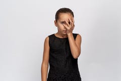 Beautiful portrait of a bored girl, half face closed by the palm. girl with black hair tired of annoying conversation royalty free stock image Beautiful portrait of a bored girl, half face closed by the palm. girl with black hair tired of annoying conversation royalty free stock image