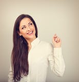 Beautiful positive business happy woman in white shirt showing idea sign by finger and looking up in white shirt and long hair. stock photos Beautiful positive business happy woman in white shirt showing idea sign by finger and looking up in white shirt and long hair. stock photos