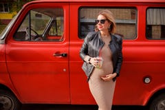 Beautiful pregnant girl is walking. Pregnant girl is standing on the street and dreaming. Hipster trendy pregnancy girl stock images Beautiful pregnant girl is walking. Pregnant girl is standing on the street and dreaming. Hipster trendy pregnancy girl stock images