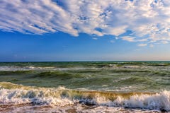 Scenic seascape with surfing waves breaking onto sandy Black sea shore by Anapa on sunny day royalty free stock photo Scenic seascape with surfing waves breaking onto sandy Black sea shore by Anapa on sunny day royalty free stock photo