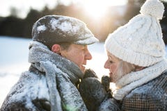 Beautiful senior couple on a walk in sunny winter nature royalty free stock photography Beautiful senior couple on a walk in sunny winter nature royalty free stock photography