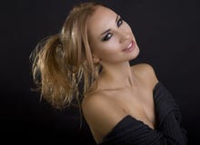 Beautiful Blond Smiling Woman. Dark Background. Smokey Eyes stock images Beautiful Blond Smiling Woman. Dark Background. Smokey Eyes stock images