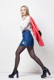 Beautiful blond woman in shirt and skirt. Girl with perfect body posing standing. Beautiful long hair and legs, smooth clean royalty free stock images Beautiful blond woman in shirt and skirt. Girl with perfect body posing standing. Beautiful long hair and legs, smooth clean royalty free stock images