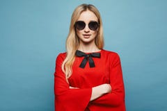 Beautiful and blonde model girl with gentle makeup in stylish sunglasses and in the fashionable short red dress royalty free stock photo Beautiful and blonde model girl with gentle makeup in stylish sunglasses and in the fashionable short red dress royalty free stock photo