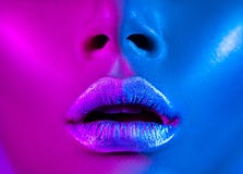 Beautiful girl, trendy glowing makeup, metallic silver lips. High fashion model woman in colorful bright neon lights