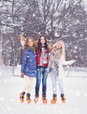 Young and pretty girl skating on outdoor open air ice-rink at wi Royalty Free Stock Photography Young and pretty girl skating on outdoor open air ice-rink at wi Royalty Free Stock Photography