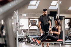 Beautiful slim girl dressed in black sport clothes is doing exercises for the abdominals on a special exercise machine royalty free stock image Beautiful slim girl dressed in black sport clothes is doing exercises for the abdominals on a special exercise machine royalty free stock image