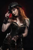 Beautiful smiling redhead cosplayer girl wearing a Victorian-style steampunk costume and hat with a big breast in a deep neckline stock photo Beautiful smiling redhead cosplayer girl wearing a Victorian-style steampunk costume and hat with a big breast in a deep neckline stock photo