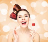 Beautiful smiling woman with a lollipop on bubbly background royalty free stock photography Beautiful smiling woman with a lollipop on bubbly background royalty free stock photography