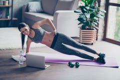 Beautiful sporty cheerful woman is doing side plank exercise. Sh royalty free stock image Beautiful sporty cheerful woman is doing side plank exercise. Sh royalty free stock image