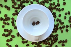 Still life with a clean coffee Cup and saucer and coffee beans scattered on the table stock photography Still life with a clean coffee Cup and saucer and coffee beans scattered on the table stock photography