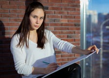 Beautiful student writes with colored pencils royalty free stock image Beautiful student writes with colored pencils royalty free stock image