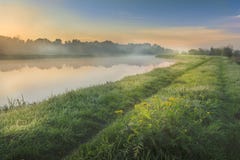 A beautiful sunrise over a misty meadow and a river Stock Photos A beautiful sunrise over a misty meadow and a river Stock Photos