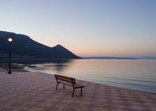 Beautiful sunset and bench on the seafront in Greece royalty free stock images Beautiful sunset and bench on the seafront in Greece royalty free stock images