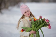 Beautiful sweet girl with a bouquet of tulips in the park in spring royalty free stock photos Beautiful sweet girl with a bouquet of tulips in the park in spring royalty free stock photos