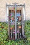 Beautiful Typical Window Of The South Of Spain Decorated With Geranium Flower Pots With A Beautiful Wall Of Mosaics Surrounded By royalty free stock photography Beautiful Typical Window Of The South Of Spain Decorated With Geranium Flower Pots With A Beautiful Wall Of Mosaics Surrounded By royalty free stock photography