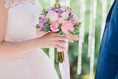 Beautiful Wedding Bouquet In Bride`s Hands. Hydrangea, Eustoma, Roses In Bride`s Bouquet. Stock Photo
