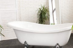 Beautiful white bath in a bright bathroom royalty free stock photos Beautiful white bath in a bright bathroom royalty free stock photos