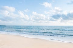 Beautiful white sand beach and ocean waves with clear blue sky