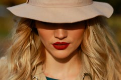 Beautiful woman in autumn hat with large brim over yellow maple garden background. close-up portrait. stock photos Beautiful woman in autumn hat with large brim over yellow maple garden background. close-up portrait. stock photos