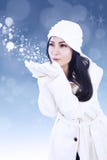 Beautiful woman blowing snowflakes Royalty Free Stock Image Beautiful woman blowing snowflakes Royalty Free Stock Image