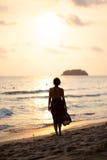 Beautiful woman in a colorful summer dress walking on the Thailand Ko Chang beach with beautiful white send during a stock photos Beautiful woman in a colorful summer dress walking on the Thailand Ko Chang beach with beautiful white send during a stock photos