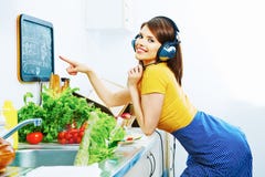 Beautiful woman cooking in kitchen and listen musi royalty free stock photography Beautiful woman cooking in kitchen and listen musi royalty free stock photography