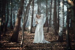 Beautiful woman dancing in ethereal forest stock photo Beautiful woman dancing in ethereal forest stock photo