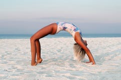 Beautiful woman doing yoga, Urdhva Dhanurasana pose on beach stock images Beautiful woman doing yoga, Urdhva Dhanurasana pose on beach stock images