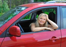 Beautiful Woman Driver In Red Shiny Car Outdoors Stock Photography