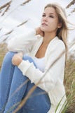 Beautiful Woman Girl Sitting in Long Grass on beach stock photo Beautiful Woman Girl Sitting in Long Grass on beach stock photo