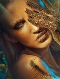 Beautiful woman with glittering golden hands and lips royalty free stock photography Beautiful woman with glittering golden hands and lips royalty free stock photography