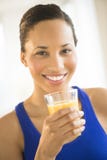 Beautiful Woman Holding Glass Of Orange Juice At Gym stock photo Beautiful Woman Holding Glass Of Orange Juice At Gym stock photo