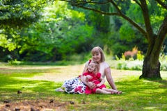 Beautiful woman and little girl having picnic in a park royalty free stock photo Beautiful woman and little girl having picnic in a park royalty free stock photo
