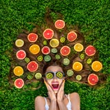 Beautiful woman lying on the grass with fruits around her hair royalty free stock photos Beautiful woman lying on the grass with fruits around her hair royalty free stock photos