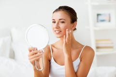 Beautiful woman with mirror touching her face skin royalty free stock photos Beautiful woman with mirror touching her face skin royalty free stock photos
