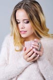 Beautiful woman in pink with a cup of hot tea
