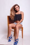 Beautiful Woman Sitting On A Chair In Shorts Jeans Royalty Free Stock Image