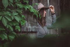 Beautiful woman in a striped shirt holding her hat. royalty free stock image Beautiful woman in a striped shirt holding her hat. royalty free stock image