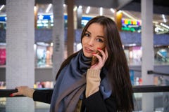 Beautiful woman talking on the phone while going out on a shopping spree royalty free stock image Beautiful woman talking on the phone while going out on a shopping spree royalty free stock image