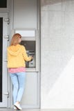 Beautiful woman using cash machine for money withdrawal outdoors royalty free stock image Beautiful woman using cash machine for money withdrawal outdoors royalty free stock image