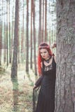 Beautiful woman witch with red hair in the forest stock photography Beautiful woman witch with red hair in the forest stock photography
